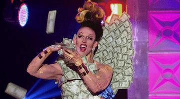 Drag queen performing on &quot;RuPaul&#x27;s Drag Race&quot; in a gown made of money while making it rain cash on the audience below