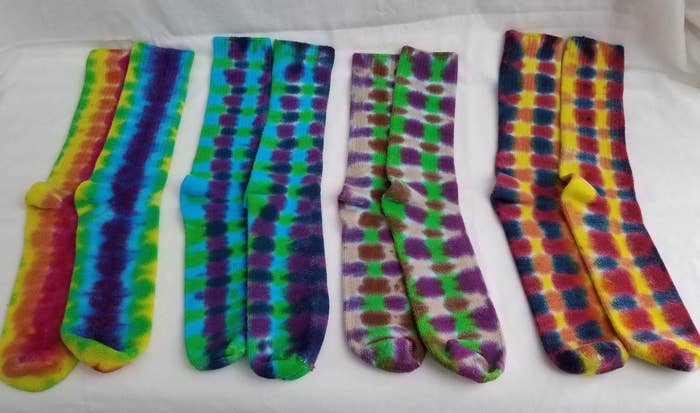 Multi-colored pairs of tie dye socks lined up 