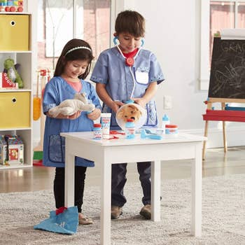 Two child models playing veterinarians with their two set