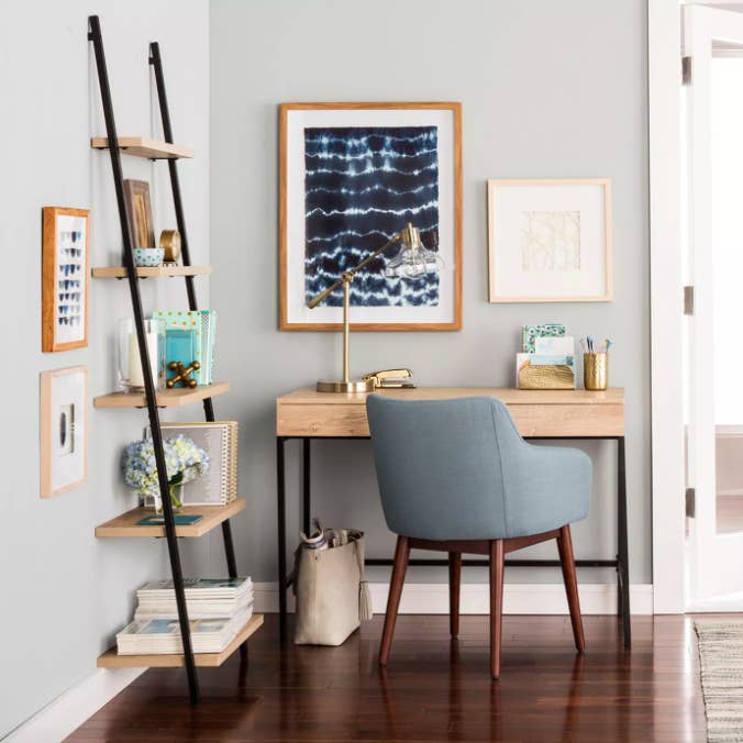 Light wood writing desk with pale blue chair and lamp 