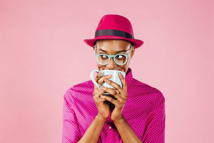 Stylish man holding a coffee mug to his mouth