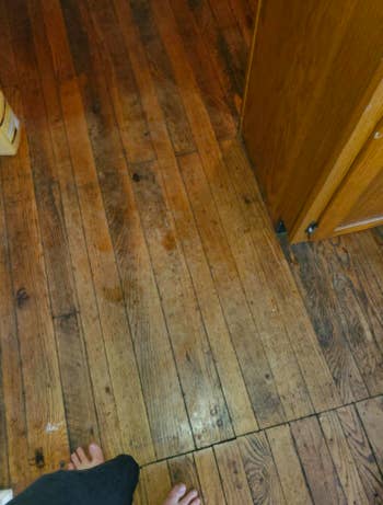 A reviewer's kitchen floors, which look uneven in color, scuffed, and dull