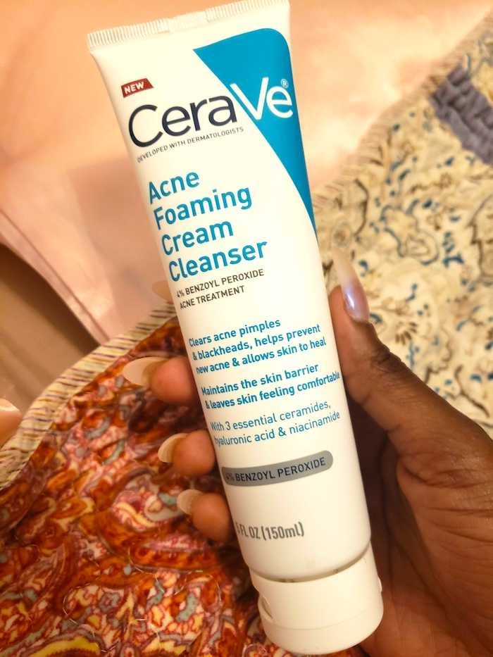 Marquaysa&#x27;s hand holding the bottle of cleanser