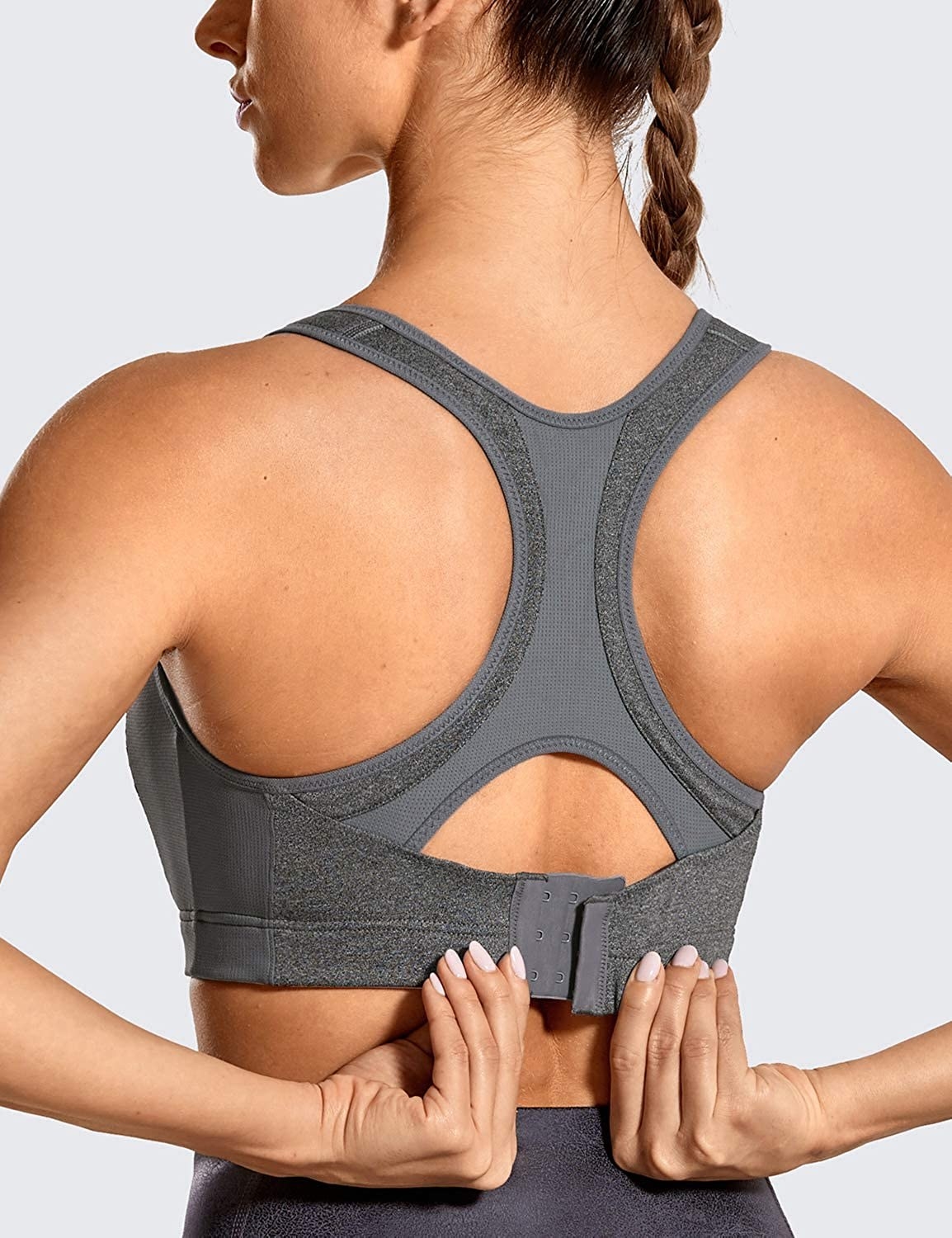 model unhooking the back clasp of the sports bra 