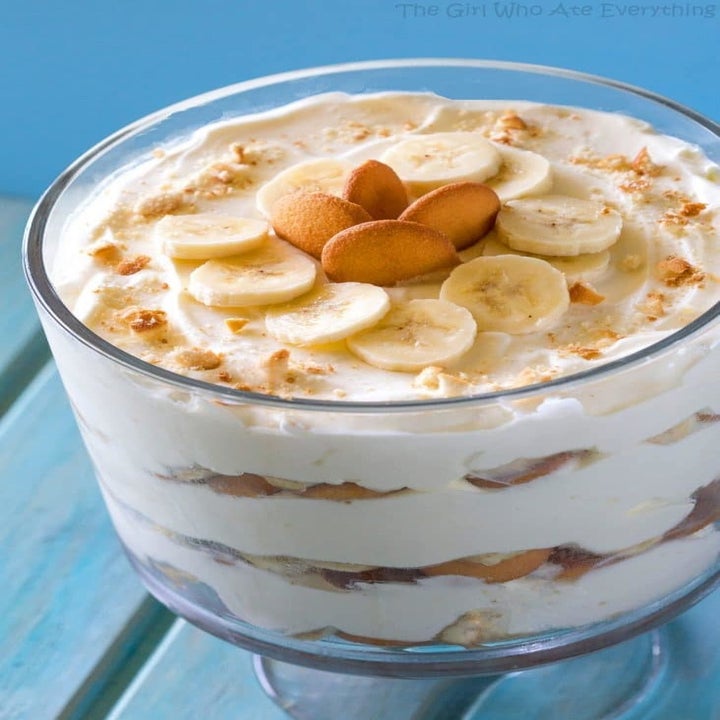 A large bowl of banana bread pudding with sliced bananas and Nilla wafers on top.
