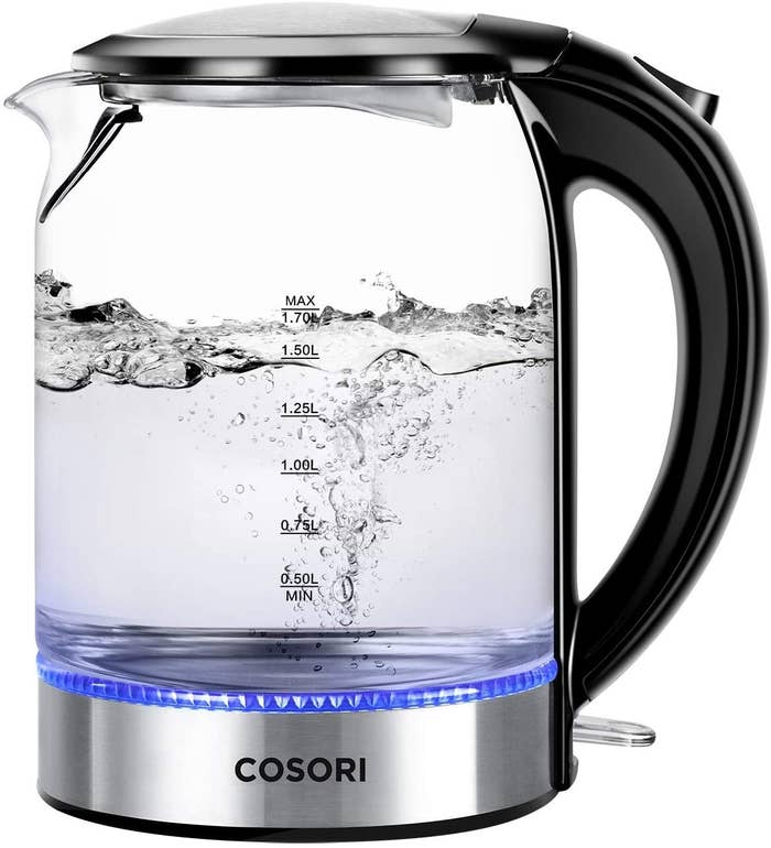 Water boiling in a clear electric kettle with black handle and metallic base