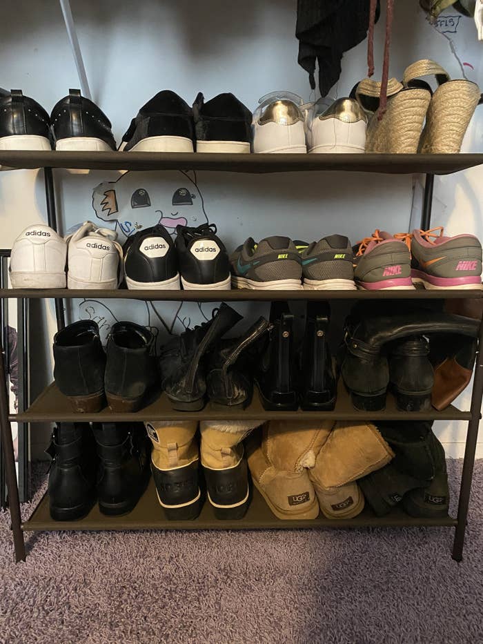 The four-tier shoe rack in bronze in Sam&#x27;s closet, with four pairs on each shelf