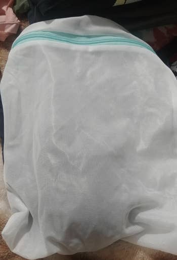 the white mesh bag with a blue zipper 