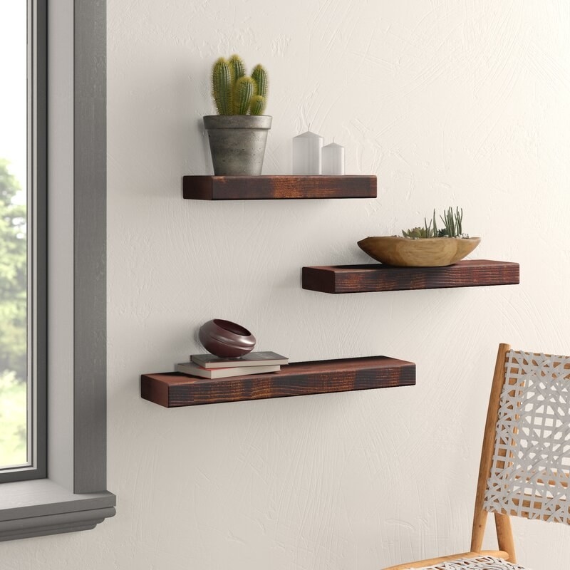 The shelves in a dark walnut finish