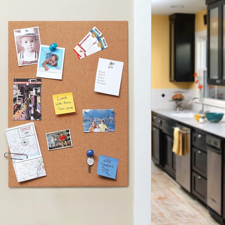 a memo board created out of the adhesive cork covering with notes stuck to it