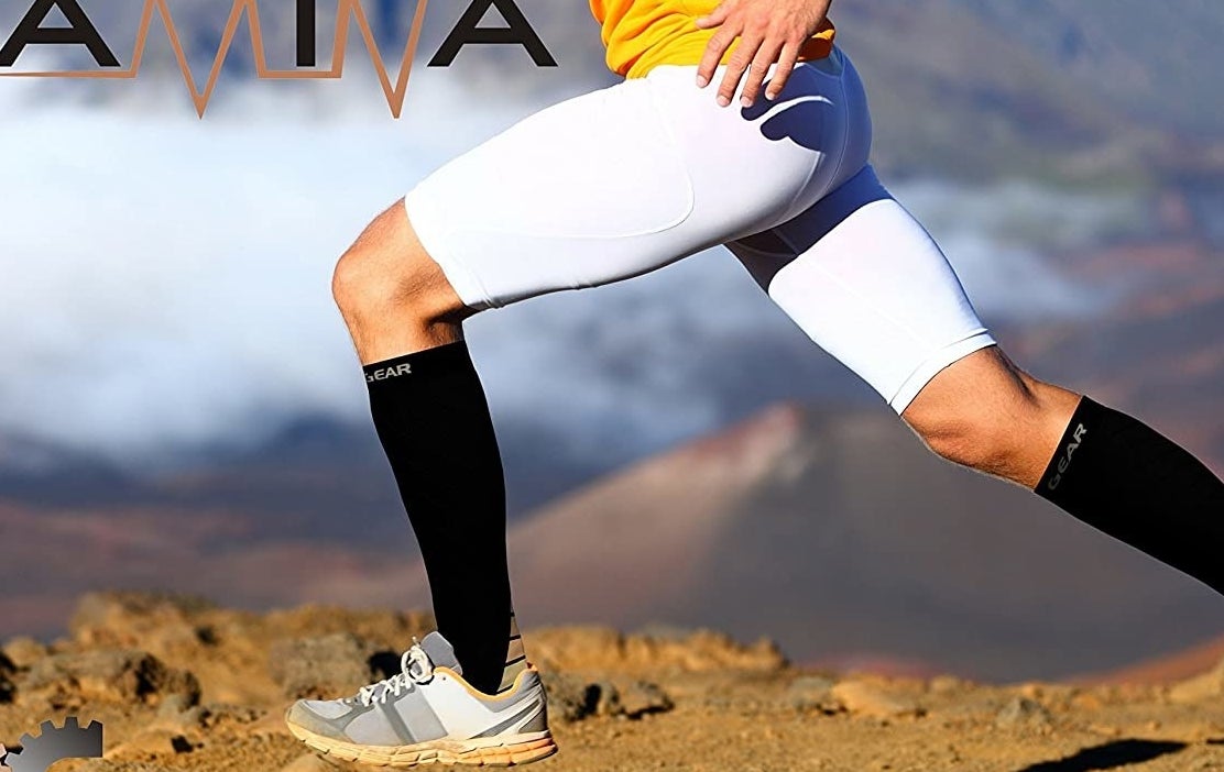 A person running on a dirt road while wearing the compression socks and shorts