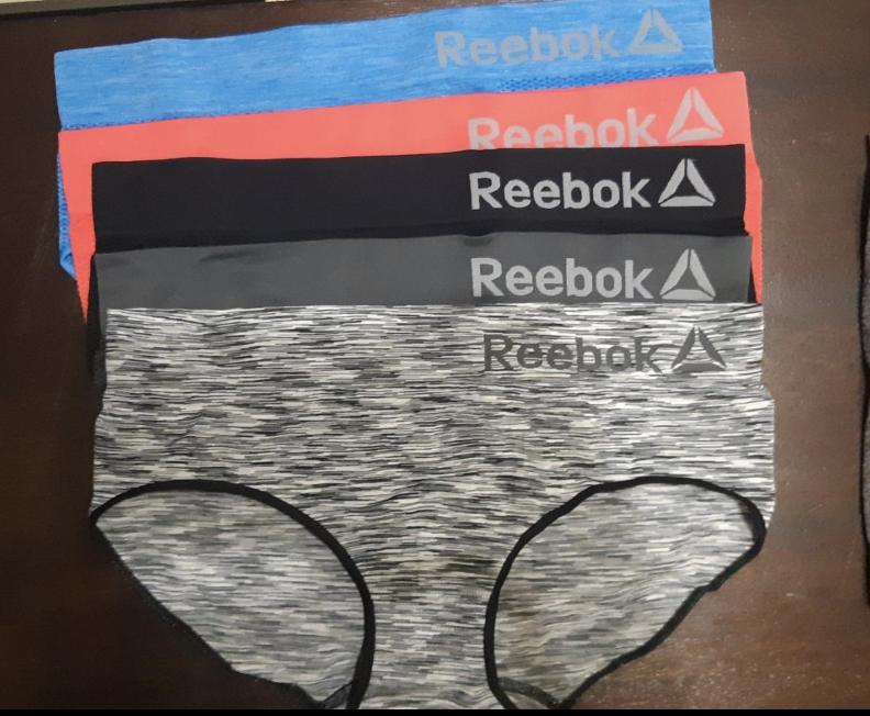 A reviewer image of the underwear in blue, orange, black, and space-dye gray 