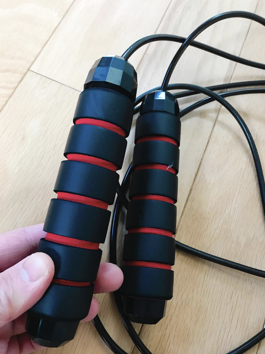 A reviewer holding the handles of the jump rope