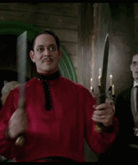 gif of Gomez Addams in The Addams Family movie dancing with two sharp knives
