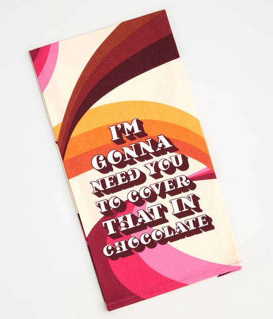 A '70s-pattern dish towel that says "I'm Gonna Need You To Cover That In Chocolate"