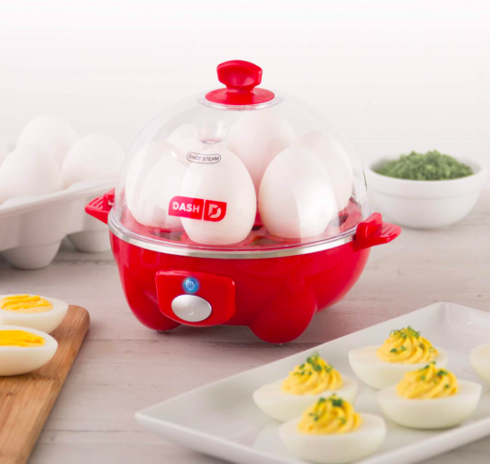 Red Dash Rapid Egg Cooker heats up six hard-boiled eggs on a table