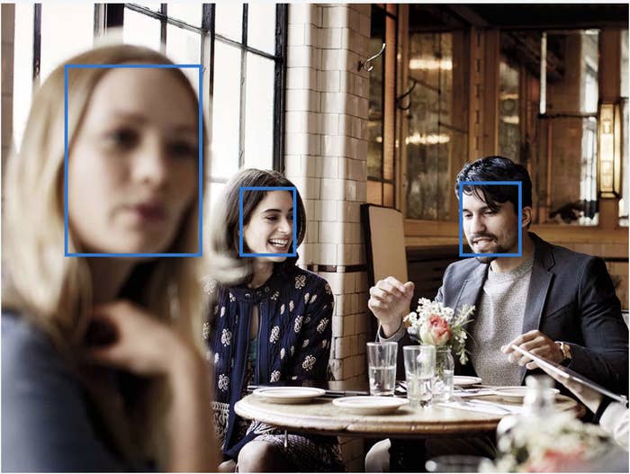 This photo shows people at a restaurant with squares around their faces, ostensibly highlighting the ability of Microsoft's Azure facial recognition service.