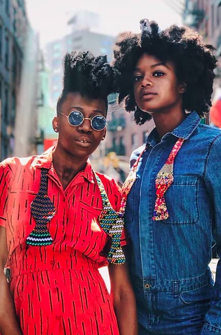 Models wear patterned neck straps with a red dress and denim jumpsuit