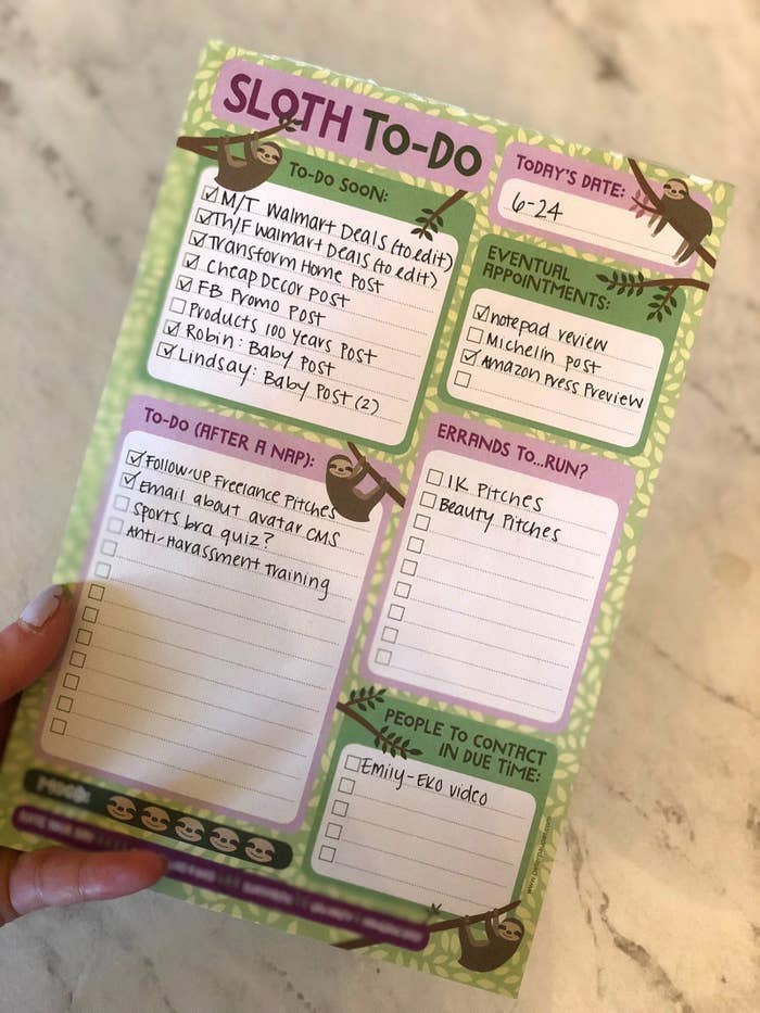 BuzzFeed Editor Emma McAnaw holding sloth checklist 