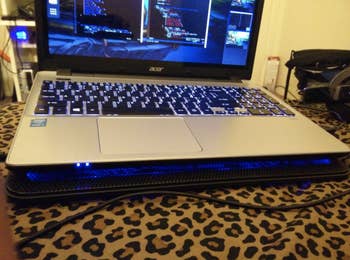 Reviewer laptop resting on thing cooling pad 