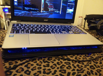 laptop resting on thing cooling pad 