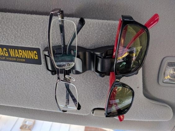 Reviewer&#x27;s photo of their glasses and sunglasses attached to their sun visor 