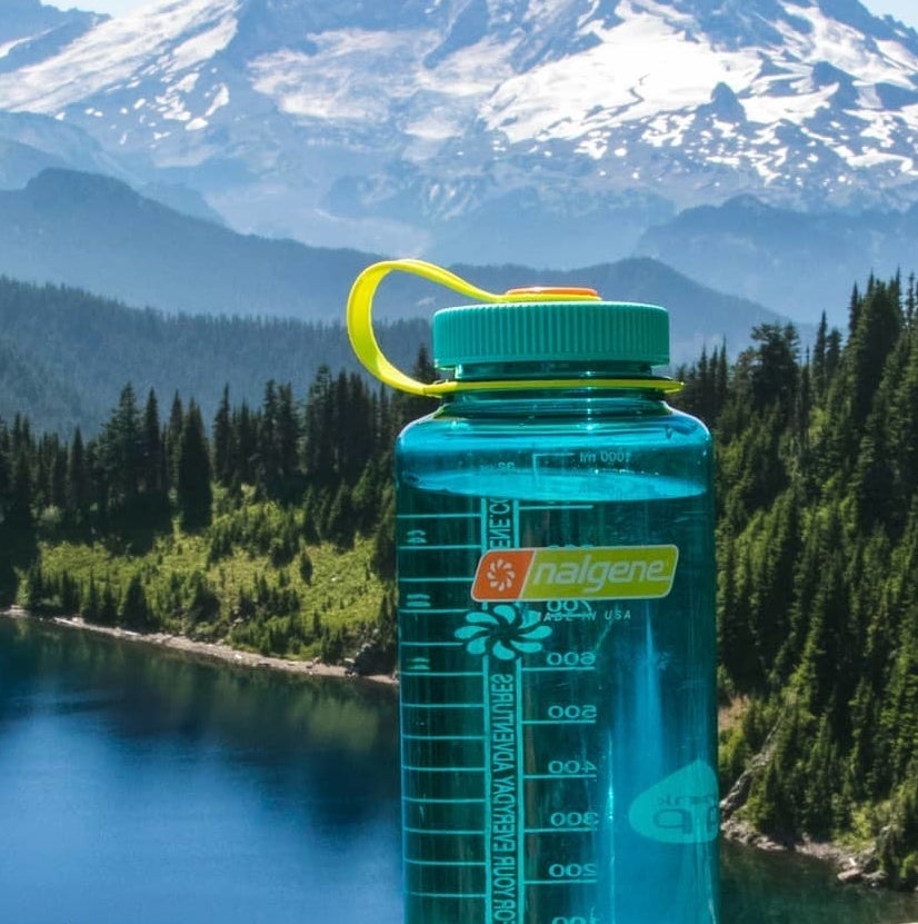 clear blue water bottle with green cap 