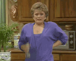 A character from Golden Girls sprays herself with a bottle of water and exhales dramatically 