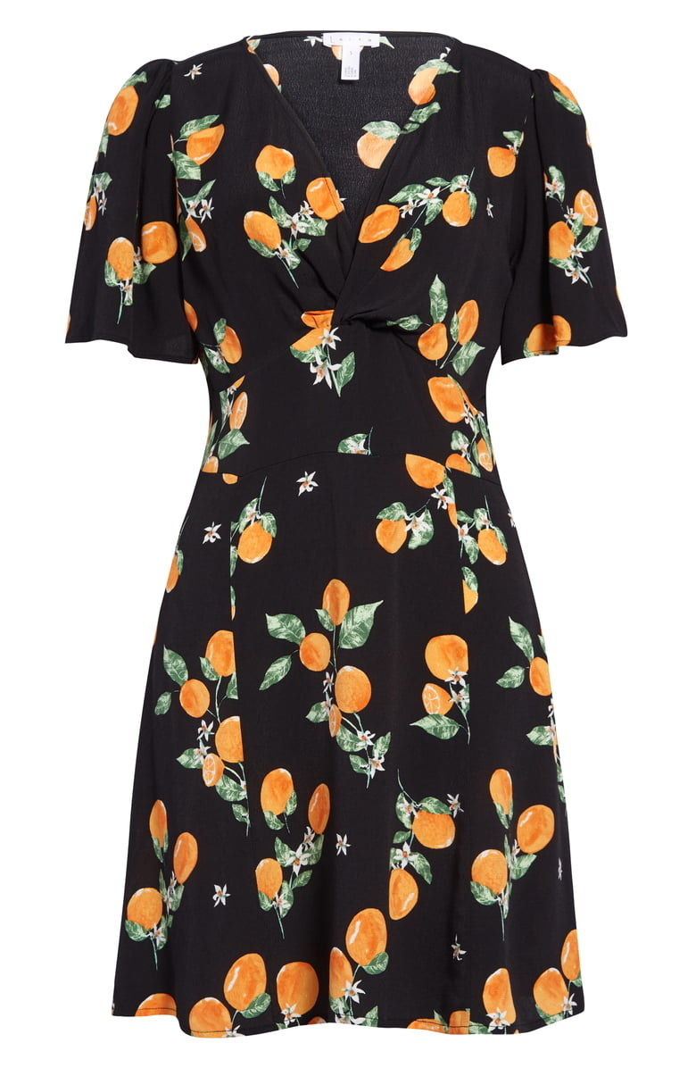 black A-line mini dress with V-neck with twist detail with peach pattern on it