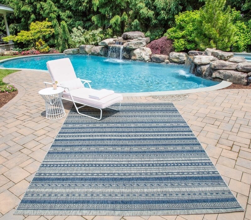 The rug in blue outdoors by a pool