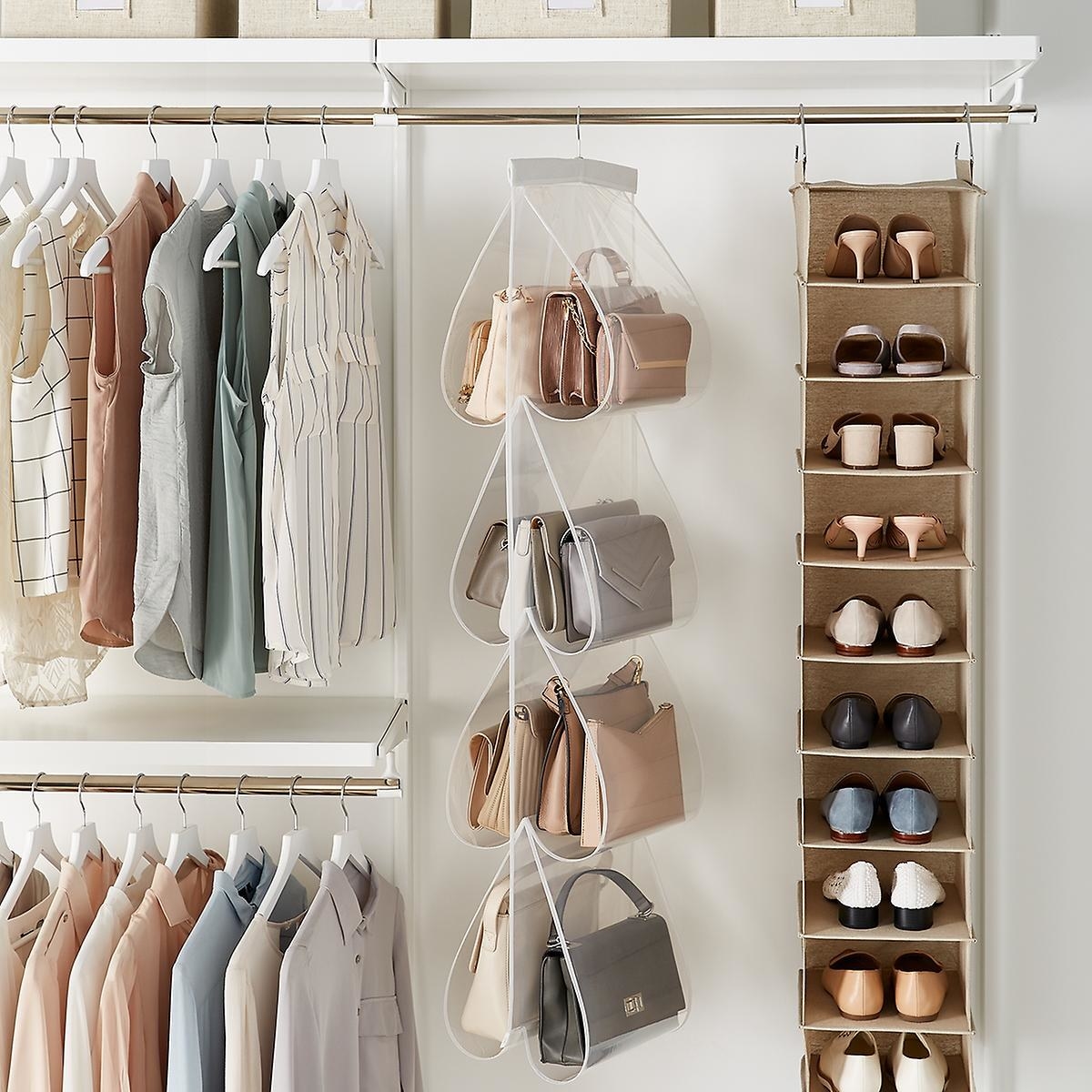 Multiple handbags hanging in the purse file inside a closet