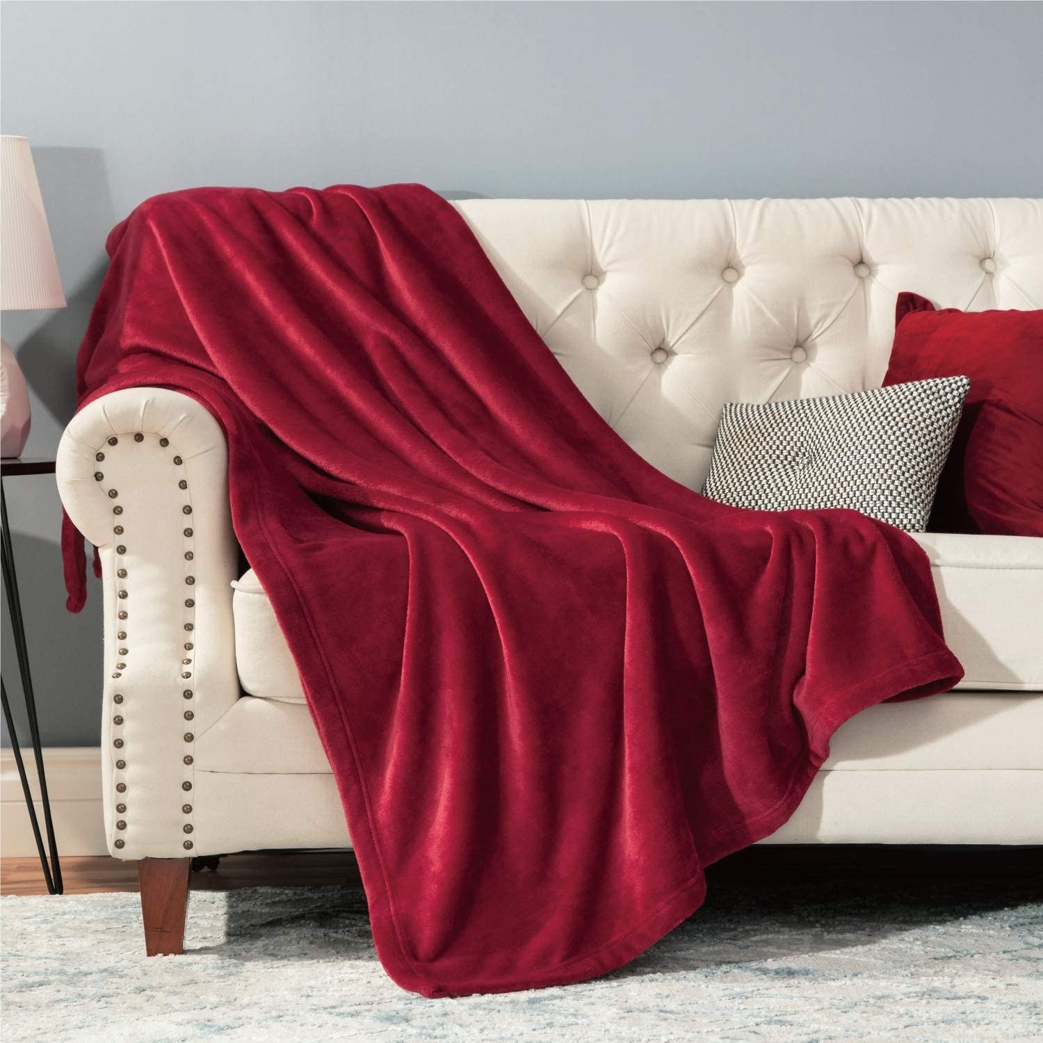 A fluffy throw is draped across a couch with pillows on it