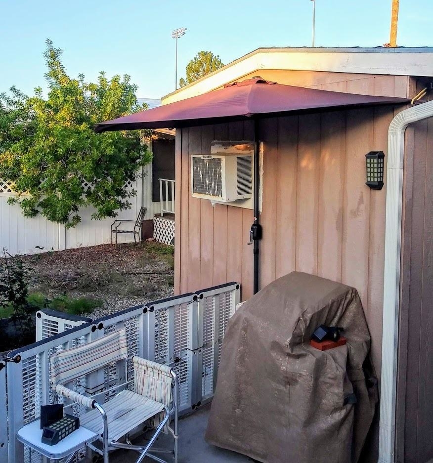 The half umbrella against the side of a shed