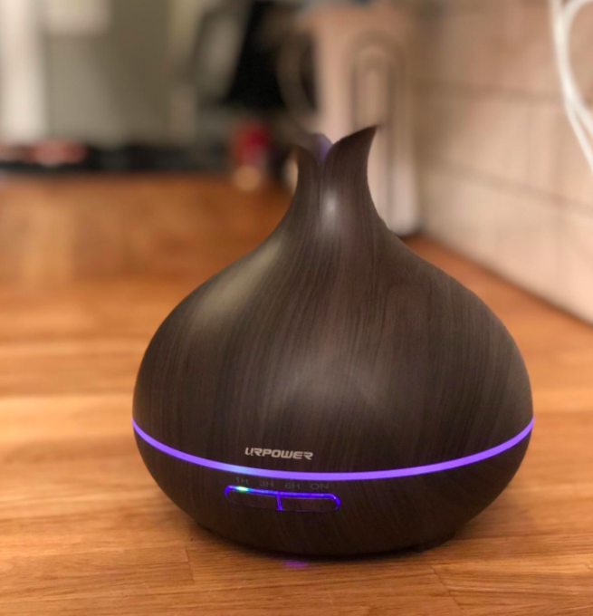 Dark wood-grain diffuser in tear drop shape and purple light on 