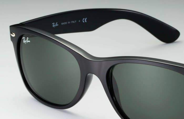 A close-up of plastic sunglass frames with glass lenses, etched with Ray-Ban signature logo