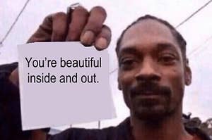Snoop Dogg holding a note saying, "You're beautiful inside and out"