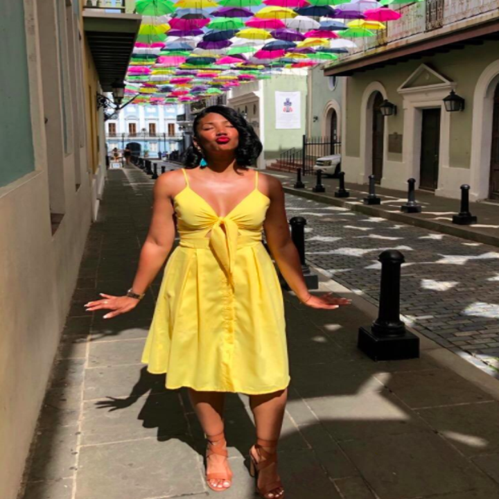 A customer review photo of the midi dress in yellow