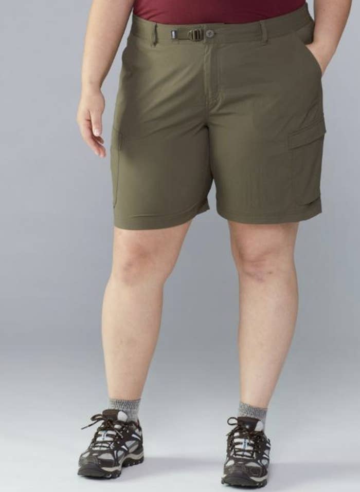 model in army green knee-length shorts with side pockets