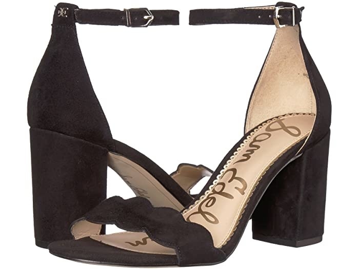 The block heels in black suede with upper strap with scalloped edge and an ankle strap