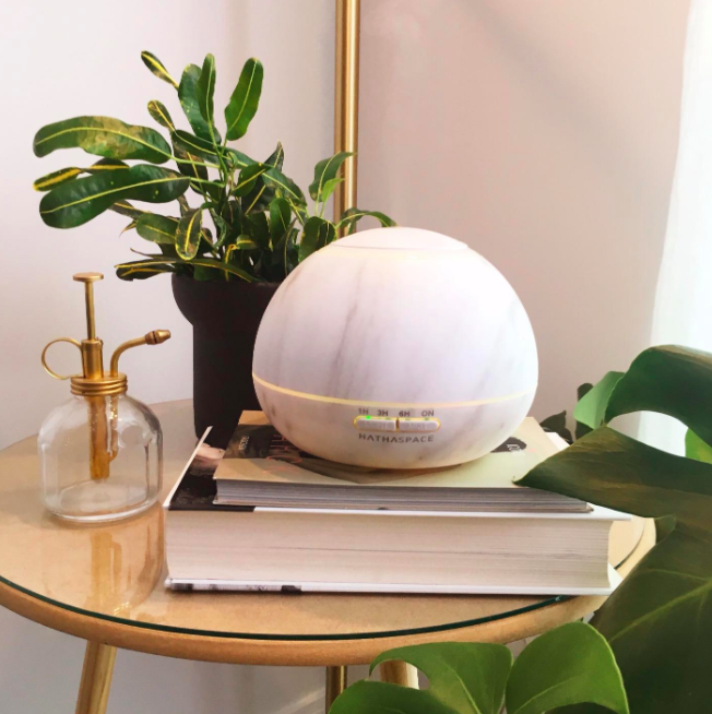 Orb-shaped marble-style diffuser sitting on end table 