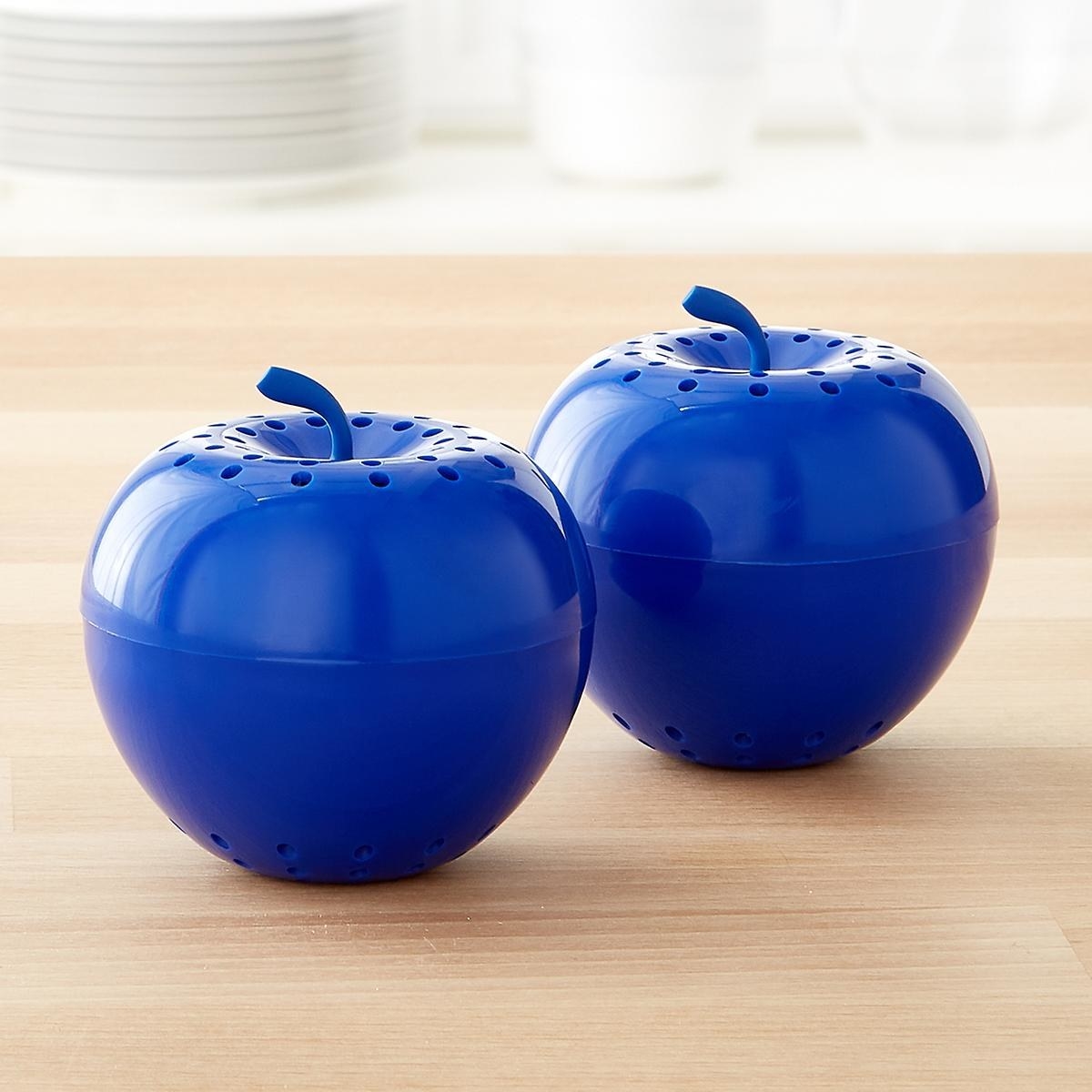 Two blue plastic apples with ventilation holes on top and on bottom