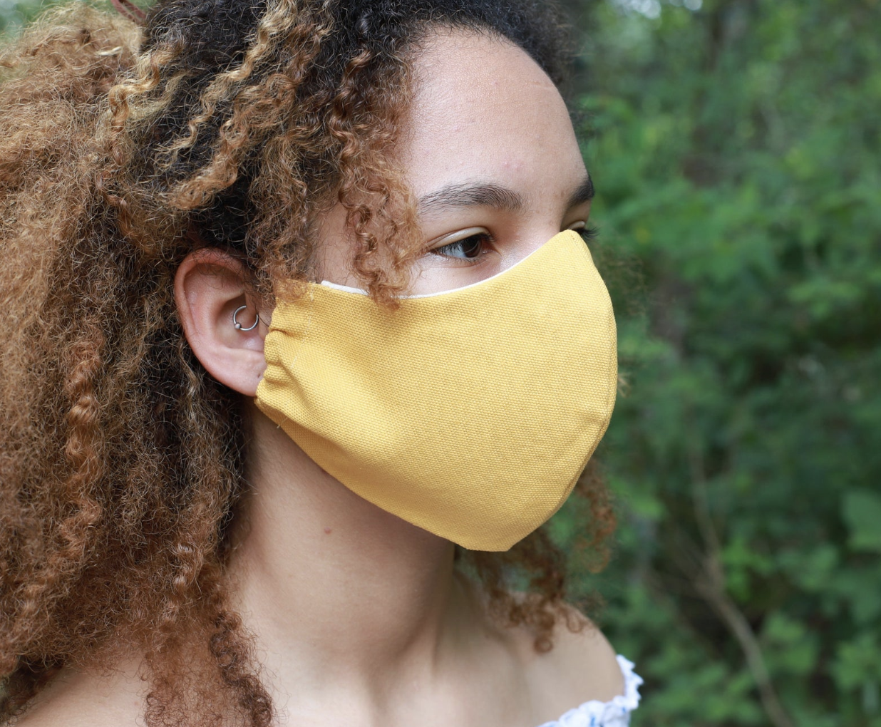 A model in a yellow canvas face mask 