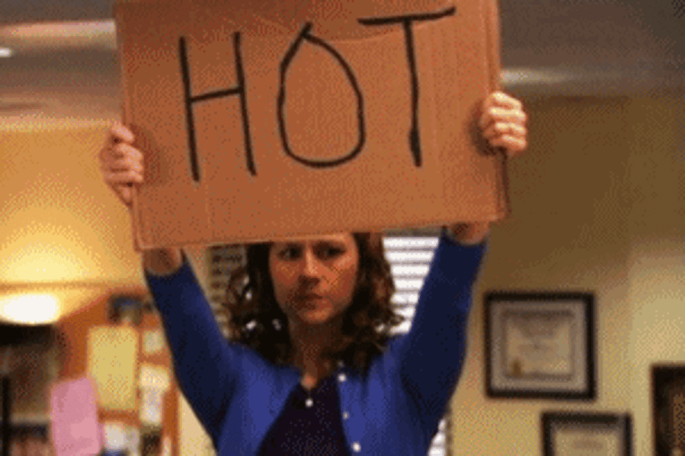 Gif of Pam from The Office holding a sign that says &quot;hot&quot;