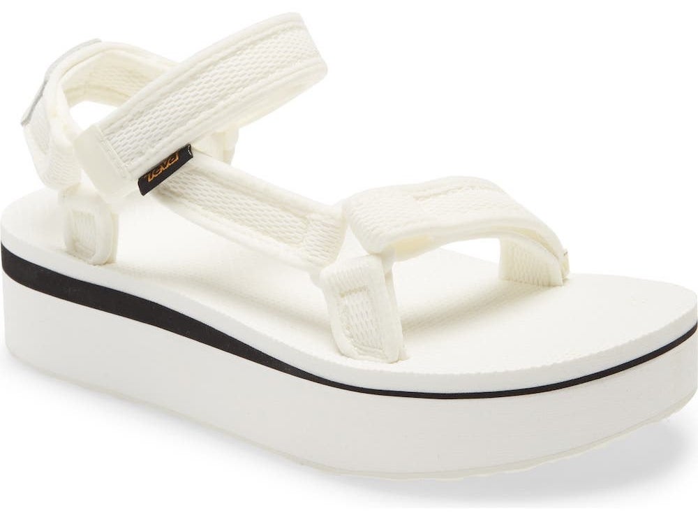 The flatforms with black stripe on the sole in white