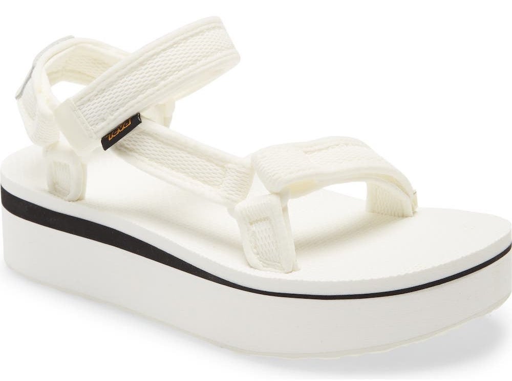 The flatforms with black stripe on the sole in white