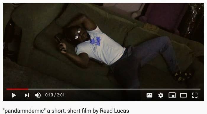A Man lays on couch remote in hand