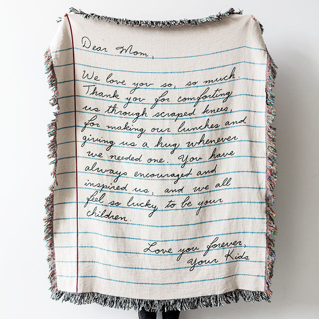 the blanket with a letter woven into it 