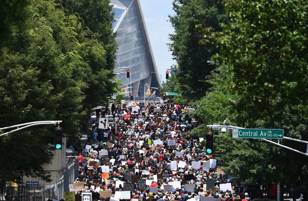 Hundreds of protesters march down a street