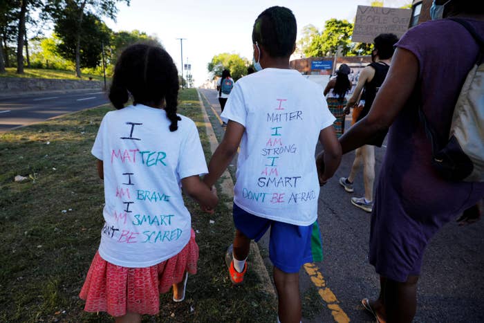 Two small children wearing shirts that read, &quot;I matter, I am brave, I am smart, don&#x27;t be scared&quot;