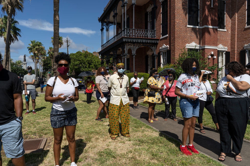 People stand in front of Ashton Villa, where the emancipation of the slaves was announced in 1865